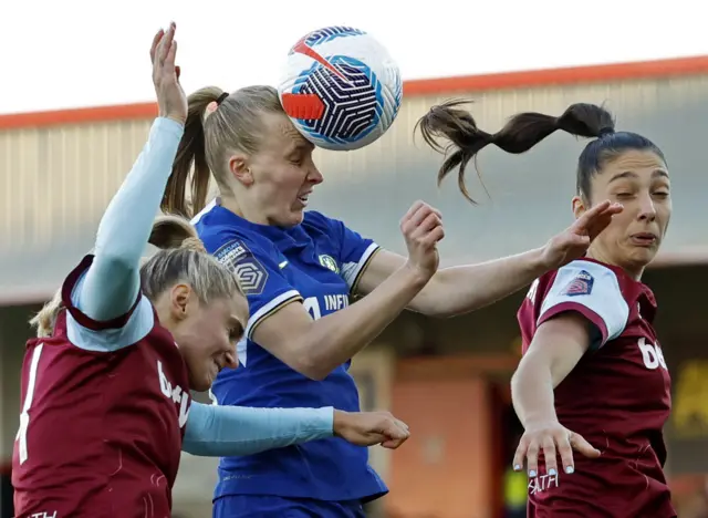 Beever-Jones heads over the bar between two defenders