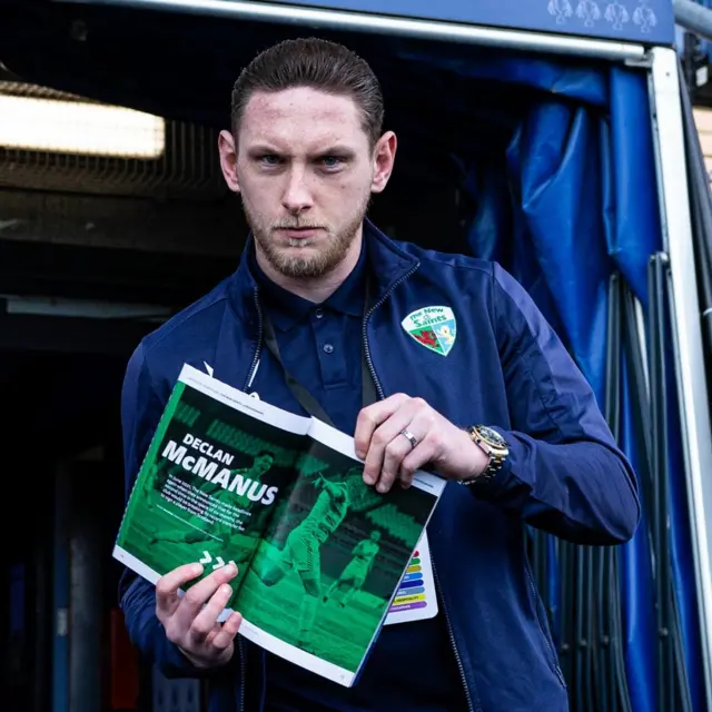 TNS' Declan McManus before the SPFL Trust Trophy Final match between The New Saints and Airdrieonians at Falkirk Stadium, holding up a match programme with an article dedicated to him inside, on March 24, 2024, in Falkirk, Scotland.