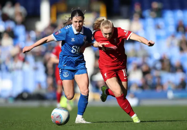 Wheeler and Holland run shoulder to shoulder towards the ball