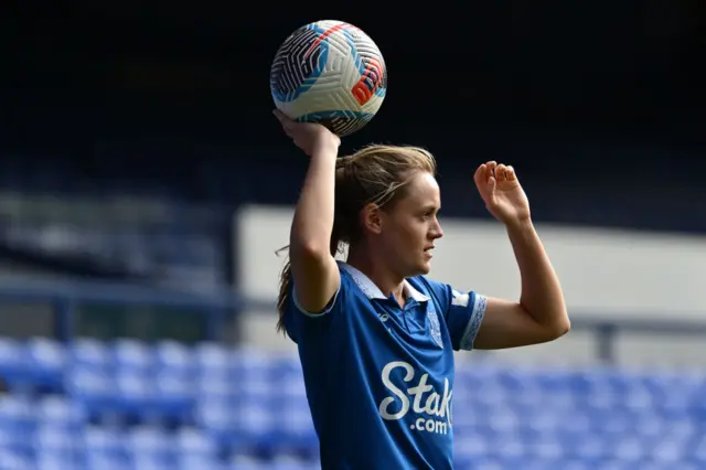 Payne prepares to take a throw in, holding the balll above her head.