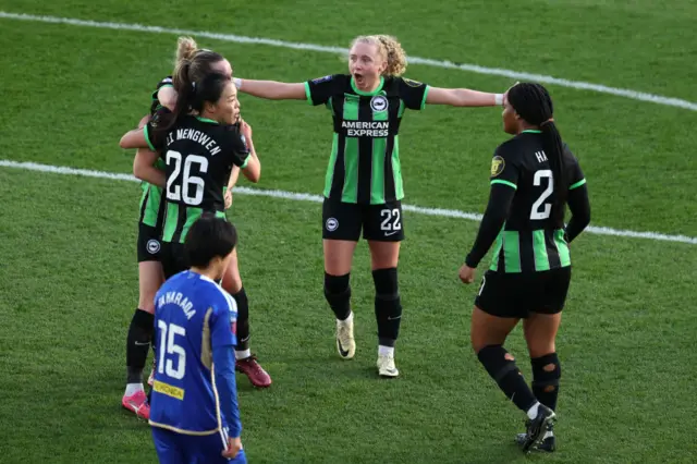 Brighton players celebrate their late winner