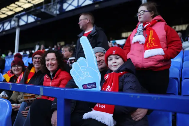 Liverpool fans sit ready in the stands ahead of kick off