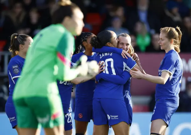 Chelsea celebrate as Arnold shouts at her defenders