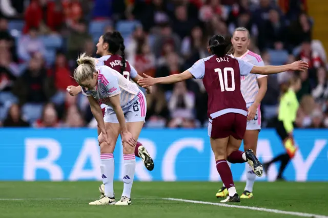 Williamson stands on her haunches as Villa players run to celebrate