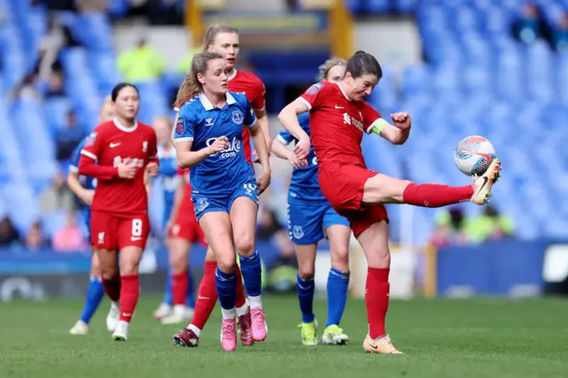 Fahey whacks the ball clear from the middle of a packed penalty area