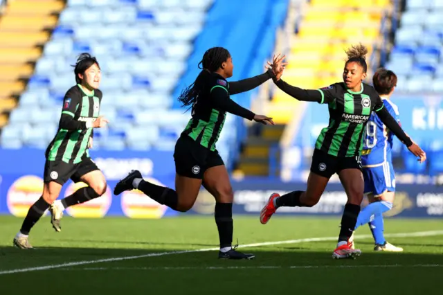 Haley and Carbali high five after their Brighton side forced an equaliser