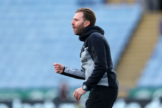 Harris gestures instructions from the touchline