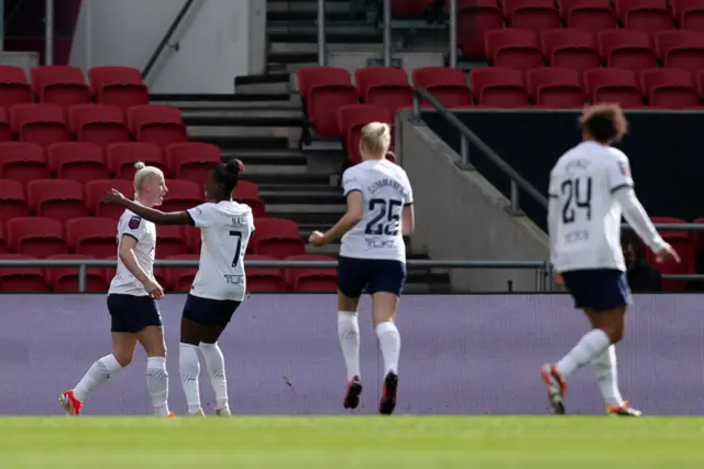 Spurs players run to celebrate with England after her goal