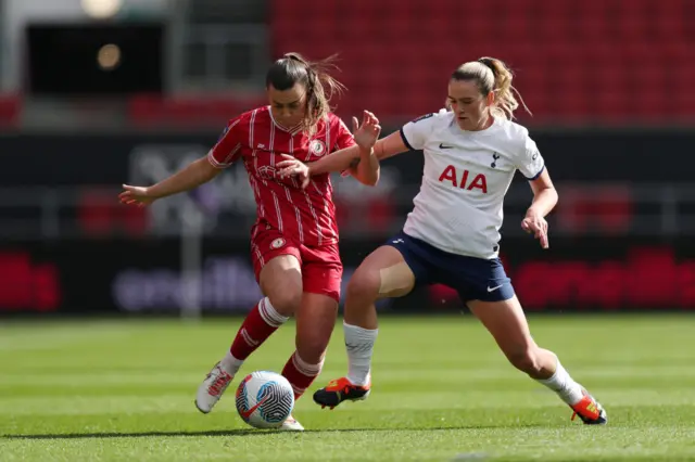 Powell is tackled by Clinton in midfield