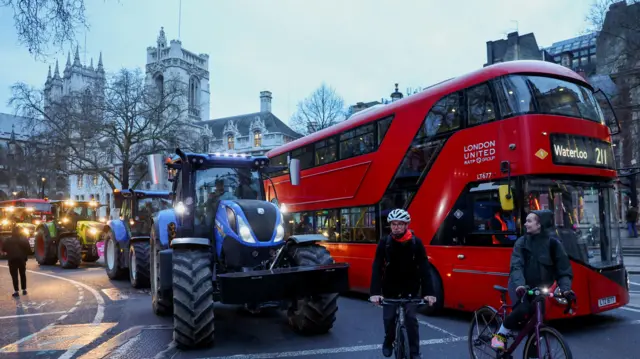 Farmers drive tractors through central London to protest against issues including food imports, as part of demonstrations from growers around the world, in London, Britai