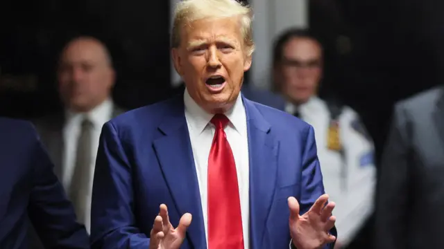 Former U.S. President Donald Trump speaks from the hallway outside a courtroom where he attended a hearing in his criminal case on charges stemming from hush money paid to a porn star in New York City, U.S., March 25, 2024.