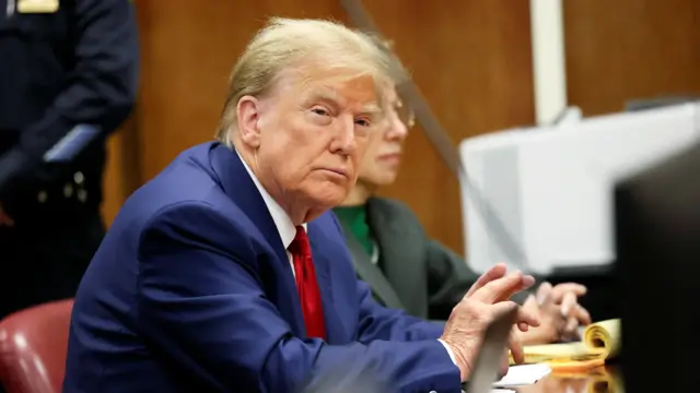 Former U.S. President Donald Trump sits in the courtroom at a hearing in his criminal case on charges stemming from hush money paid to a porn star in New York City, U.S., March 25, 2024.