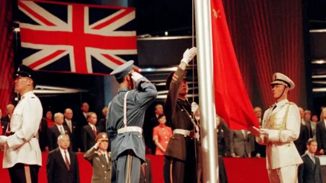 The Chinese flag is raised by People's Liberation Army (PLA) soldiers at the handover ceremony on 1 July 1, 1997