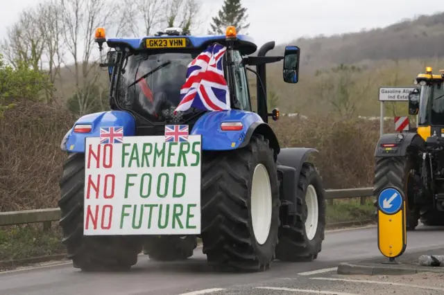 A tractor with a sign reading 'no farmers, no food, no future'