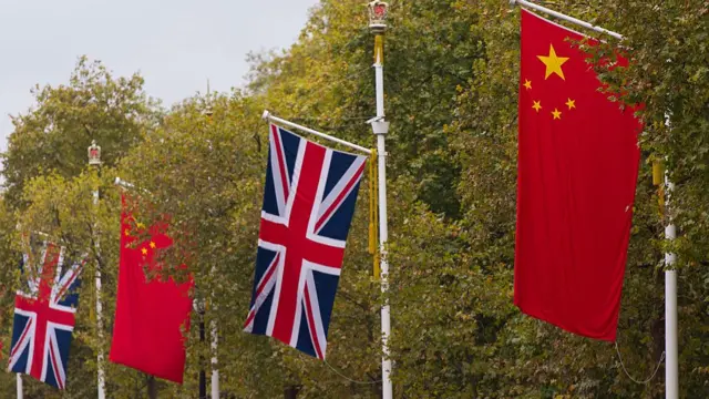 The British Union Jack flag and the Chinese Wu Xing Hong Qi flag line The Mall