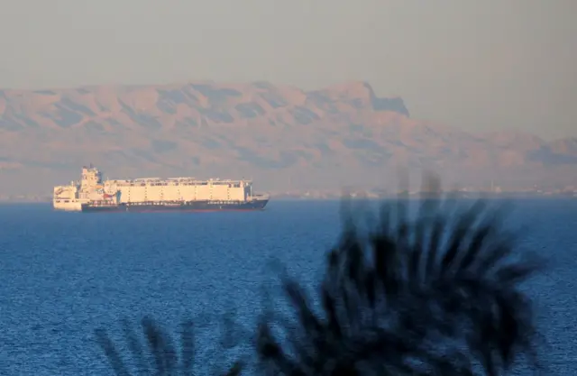 Container ships sail across the Gulf of Suez towards the Red Sea