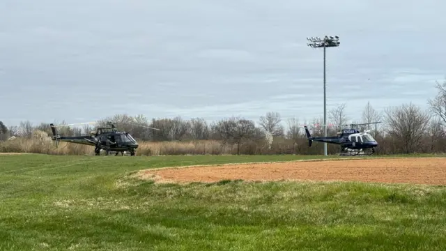 Bseball field with two police helicopters on it near the collapsed Francis Sott Key bridge in Baltimore