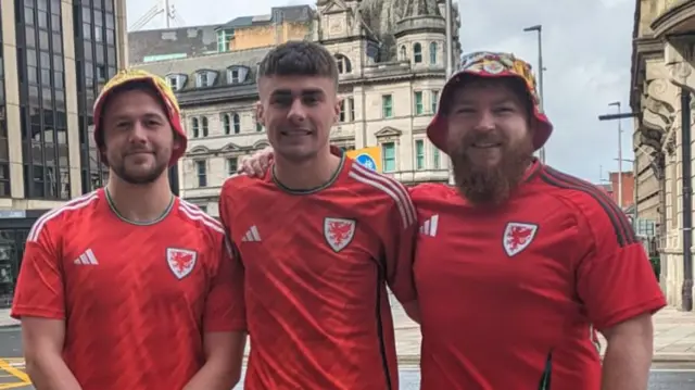 (Left to right) Lewis Webster, Curtis Walter and Conor Thomas wearing their Welsh shirts in Cardiff city centre