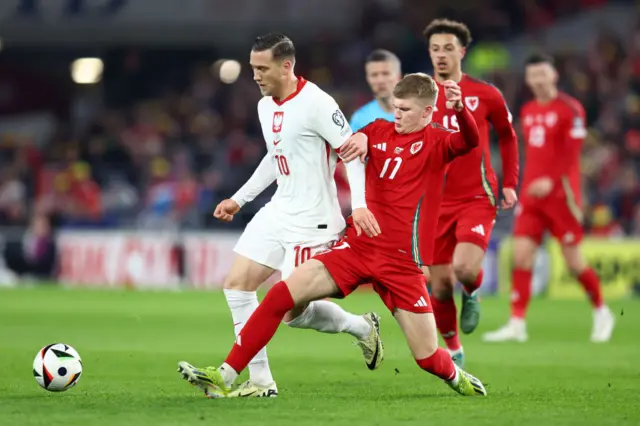 Wales midfielder Jordan James makes a tackle