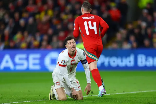 Poland's Robert Lewandowski picks himself up off the floor