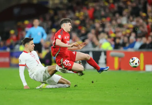 Wales' Daniel James is tackled