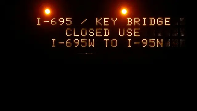 An electronic road sign reads: I-695 Key Bridge closed, use I-695W to I-95N