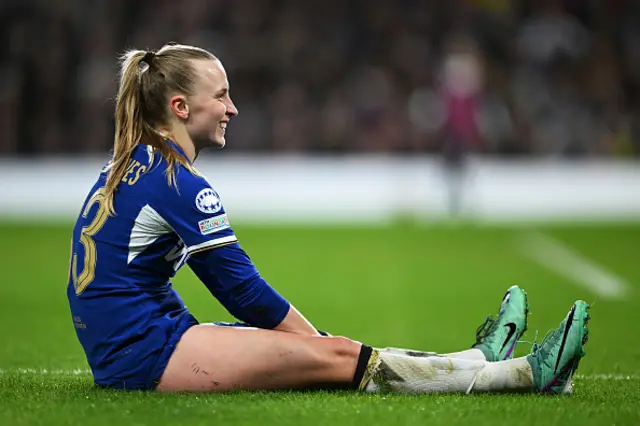 Aggie Beever-Jones of Chelsea reacts sat on the grass