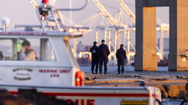 Rescue personnel gather on the shore of the Patapsco River after a container ship knocked down the Francis Scott Key Bridge in Baltimore, Maryland, USA, 26 March 2024