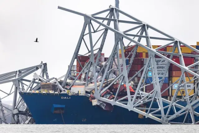 Wreckage from the Francis Scott Key Bridge surrounds the 984-foot cargo ship Dali