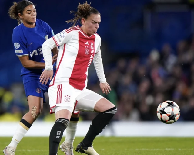 Jess Carter (left) and Ajax's Romee Leuchter battle for the ball