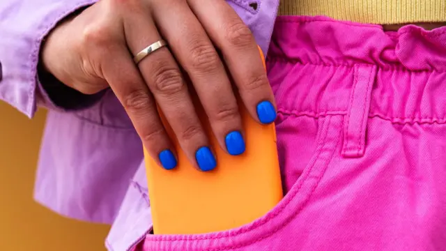 A woman holding a smartphone.