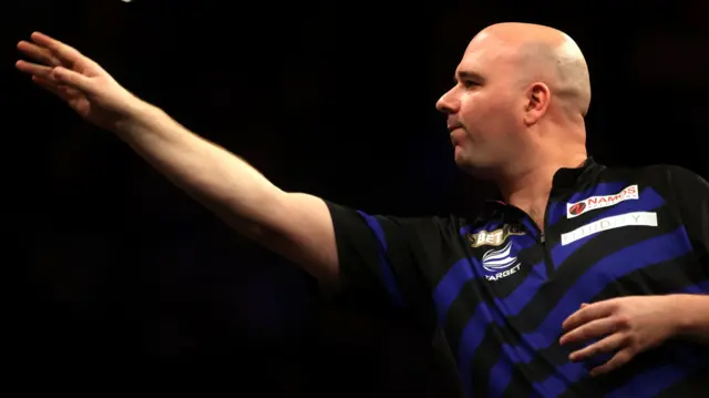 Rob Cross throws a dart