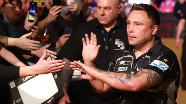 Gerwyn Price shakes hands with supporters