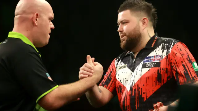 Michael Smith shakes hands with Michael van Gerwen