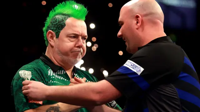 Peter Wright shakes hands with Rob Cross