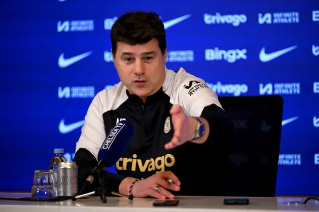 Chelsea boss Mauricio Pochettino points at a news conference