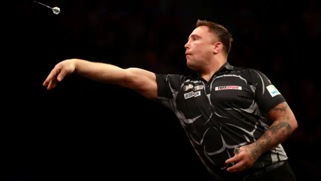 Gerwyn Price throws a dart