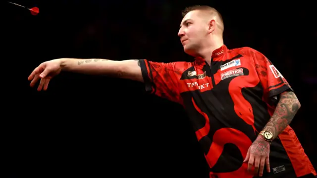 Nathan Aspinall throws a dart