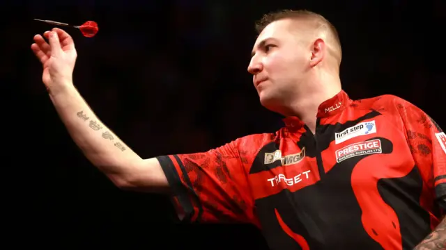 Nathan Aspinall throws a dart