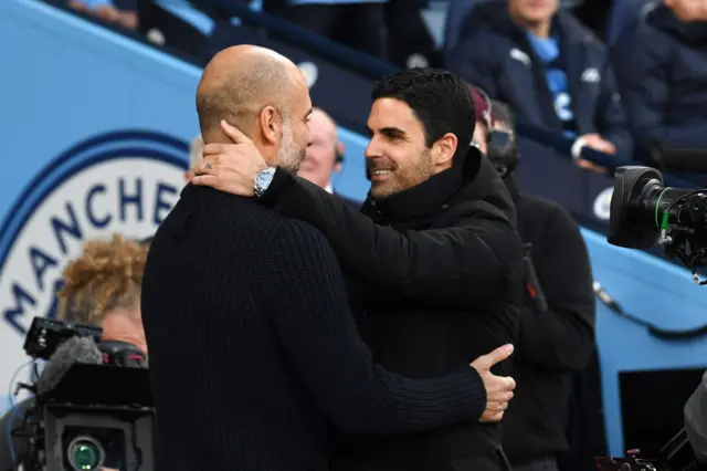 Pep Guariola and Mikel Arteta embrace