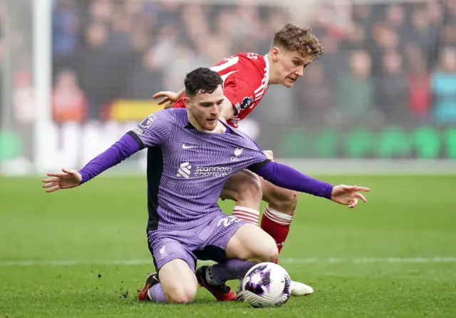 Liverpool's Andrew Robertson shields the ball from Nottingham Forest's Ryan Yates