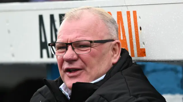 Stevenage manager Steve Evans on the bench at Carlisle