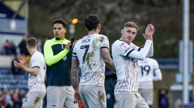 Portsmouth players applaud the fans away to Wycombe