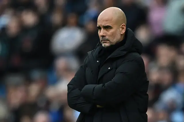 Pep Guardiola looks on