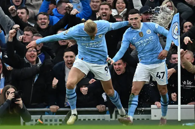 Phil Foden (R) celebrates with Manchester City's Norwegian striker Erling Haaland