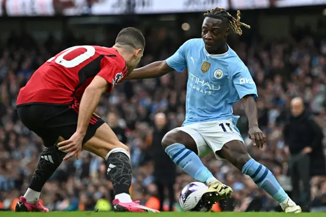 Jeremy Doku takes on Diogo Dalot