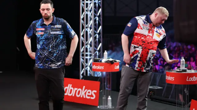 Luke Humphries and Ricky Evans leave the stage