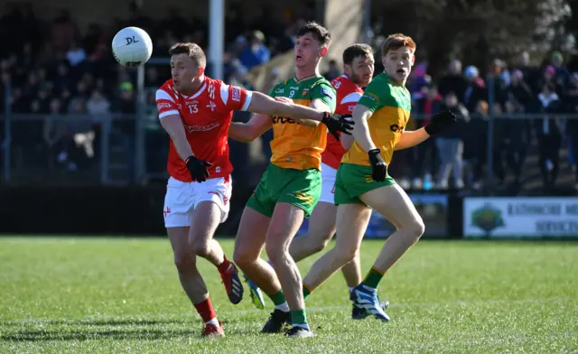 Donegal's Michael Langan battles with Louth's Ryan Burns