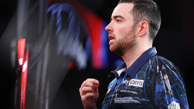 Luke Humphries stands on the oche