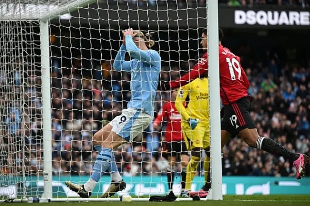 Erling Haaland (C) reacts after missing a good chance